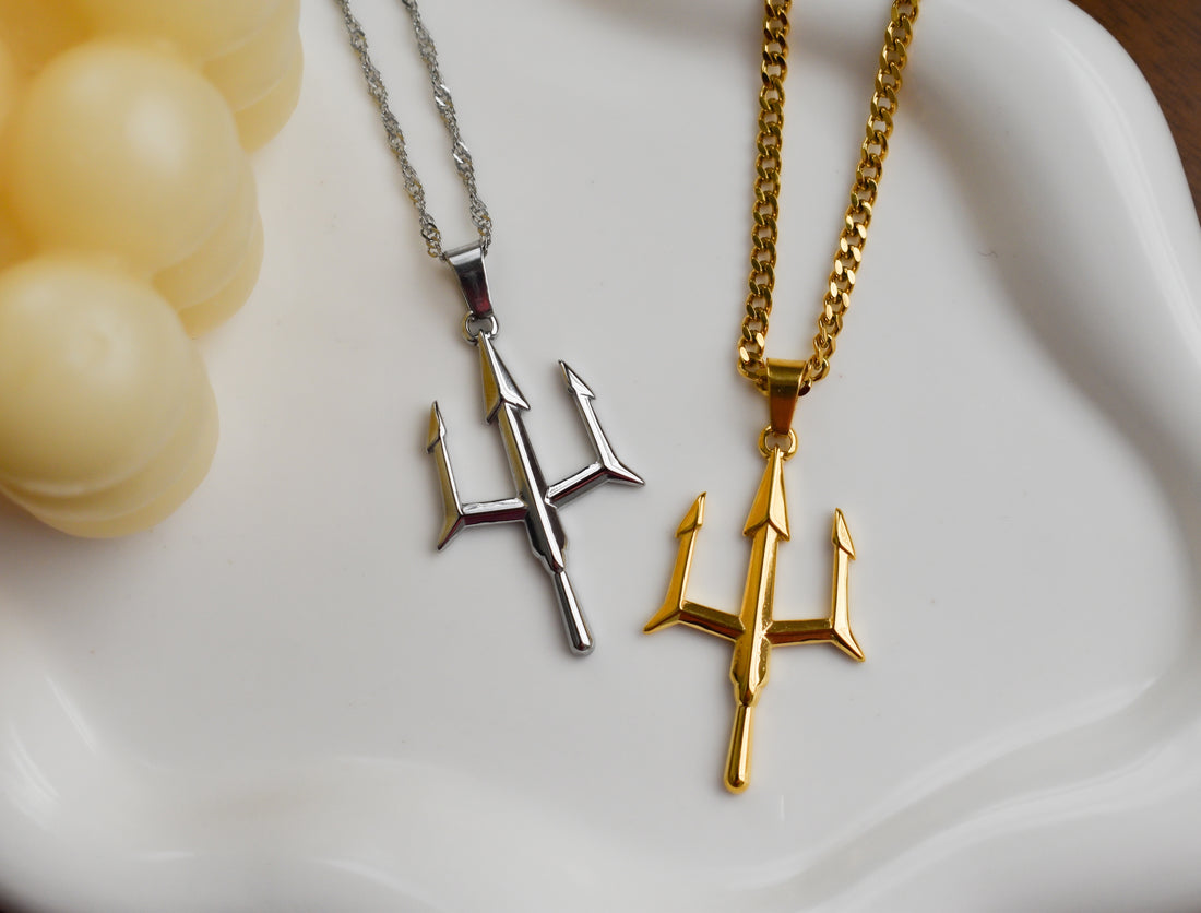 a couple of necklaces sitting on top of a white plate