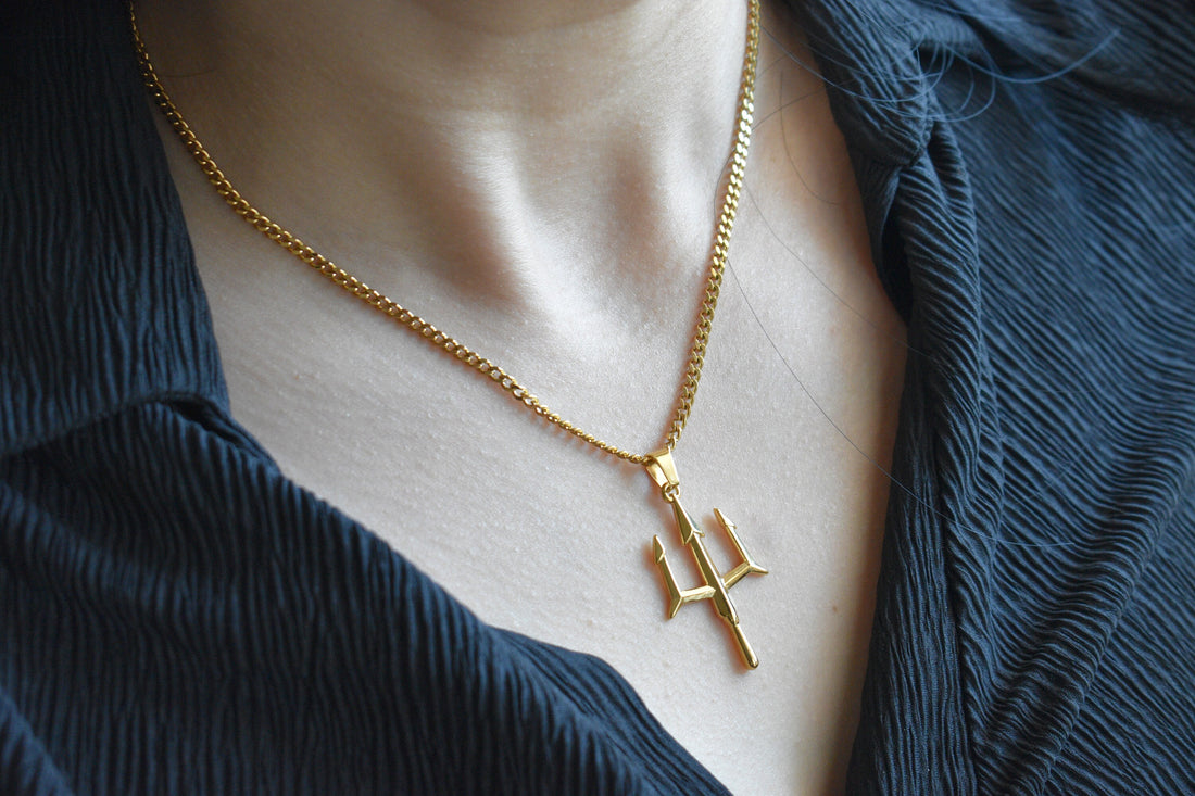 a couple of necklaces sitting on top of a white plate